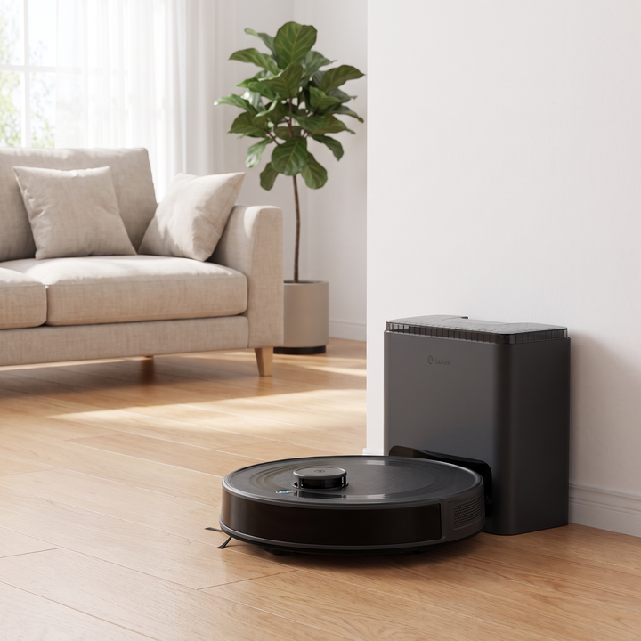 Self-Emptying Robot Vacuum and base station in a living room