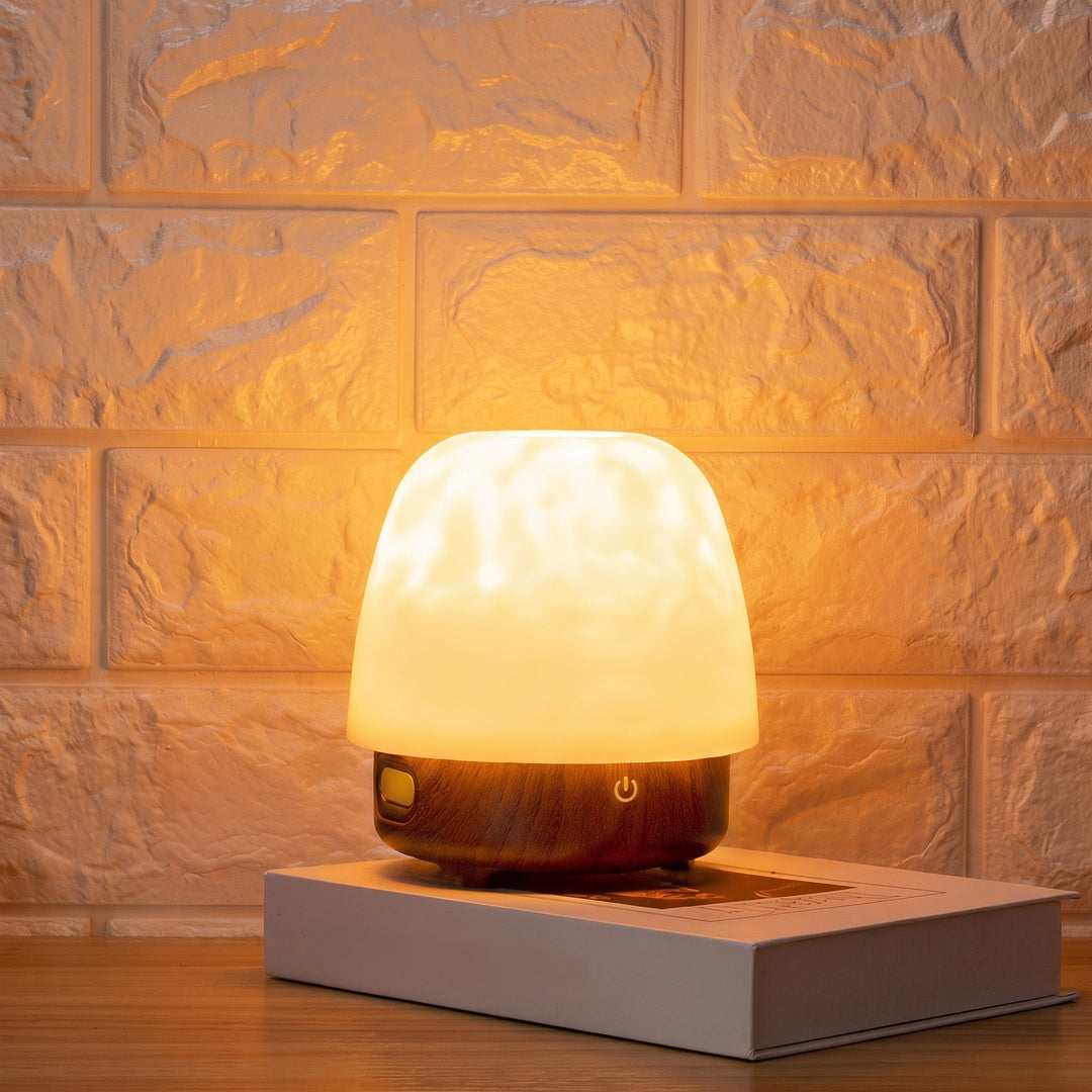 Crystal water ripple table lamp lit on a shelf